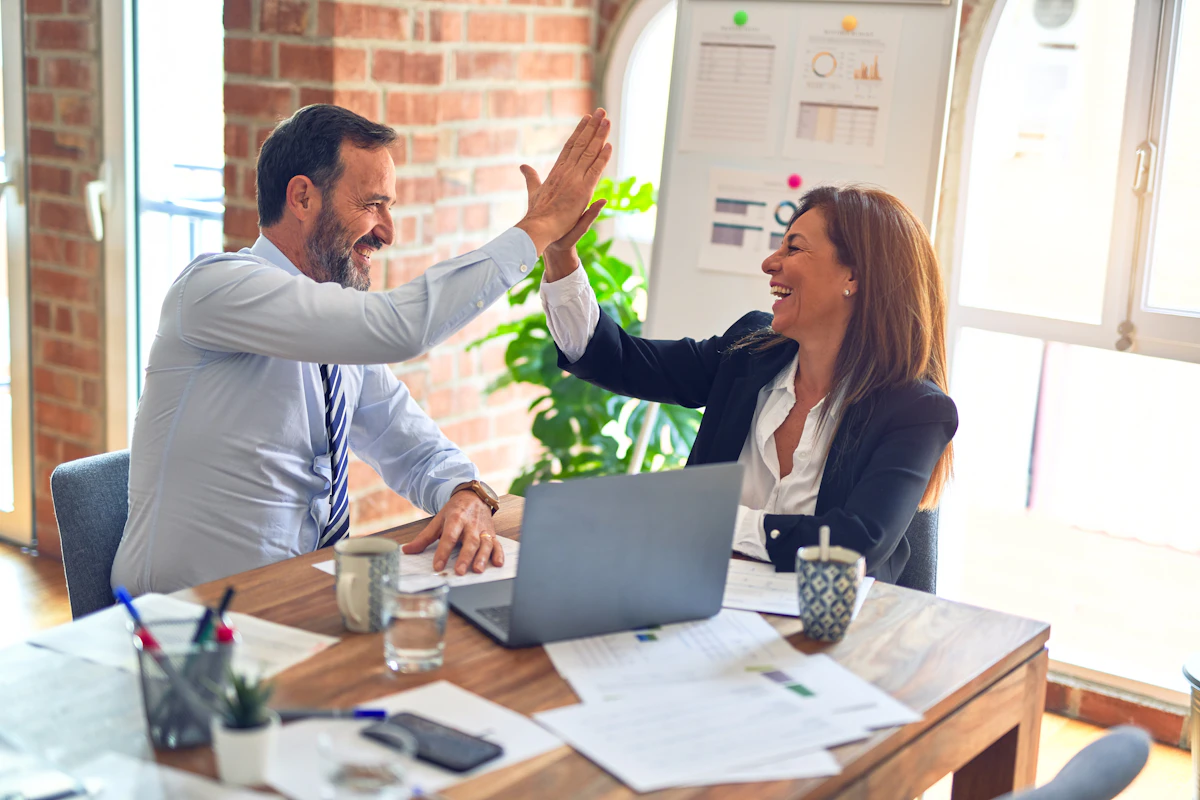 Two business partners celebrating a closed trade agreement